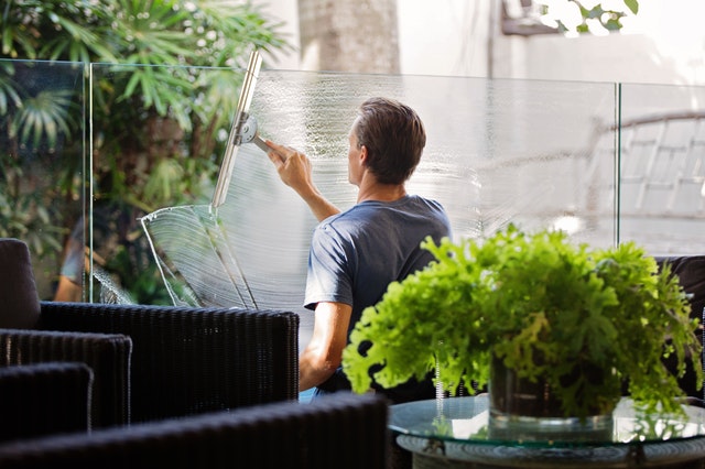 Man in grey shirt cleaning