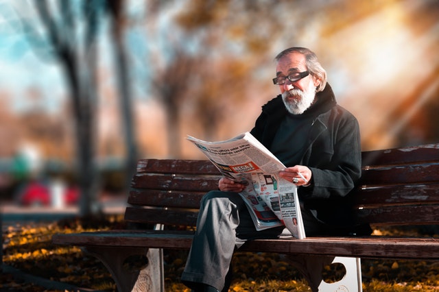 Old man reading paper